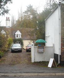 Gate side stand with cottage in the background