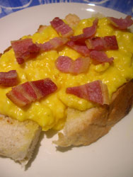 deluxe scrambled egg and streaky bacon breakfast