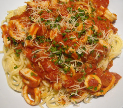 Squid in marinara sauce over spaghetti