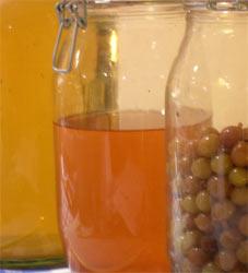 Glass jars of homemade grape wine and grape liqueurs