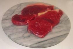 Photo of two sirloin steaks on a marble cutting board